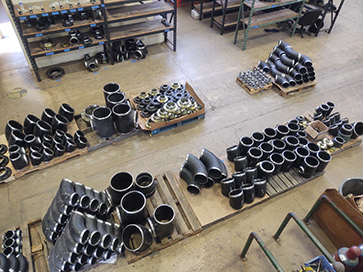 Aerial view of PMI's pipe fabrication shop in Huntington Beach, showing fabricated steel pipe in a variety of sizes and shapes.